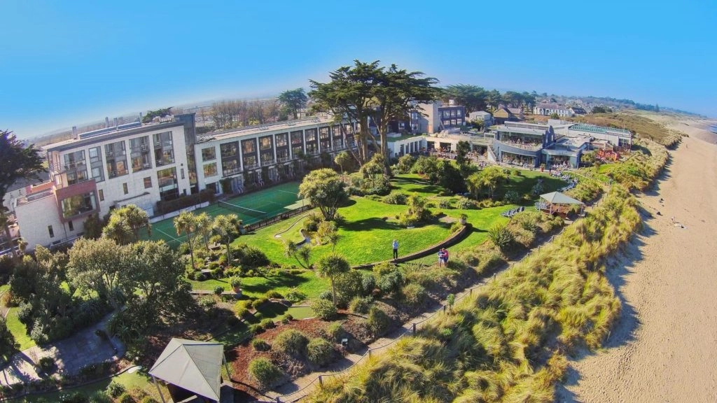 Aerial view of Kelly's Resort, beach and grounds under a blue sky.