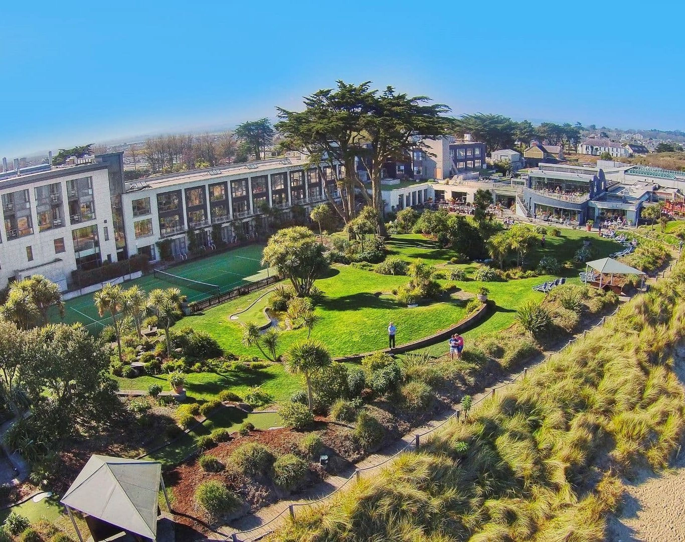 Aerial view of Kelly's Resort, beach and grounds under a blue sky.