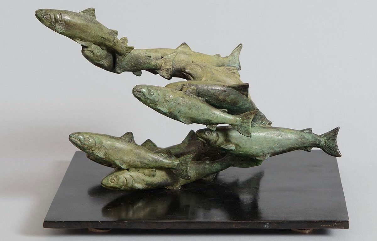 Bronze sculpture of salmon leaping upwards, adding artistic charm to our luxurious hotel lobby.