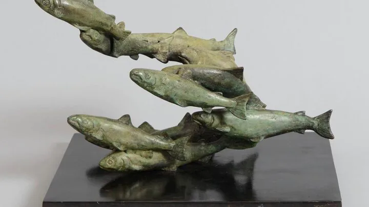 Bronze sculpture of salmon leaping upwards, adding artistic charm to our luxurious hotel lobby.